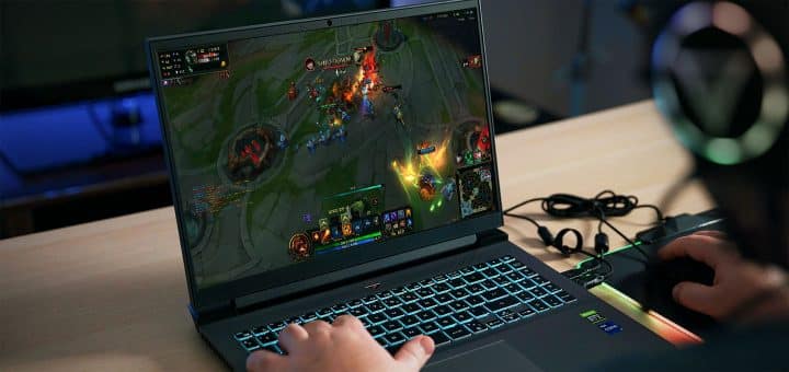 Playing League of Legends on a laptop.